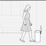 Woman is opening the trash can lid